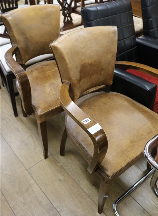 A pair of French leather elbow chairs